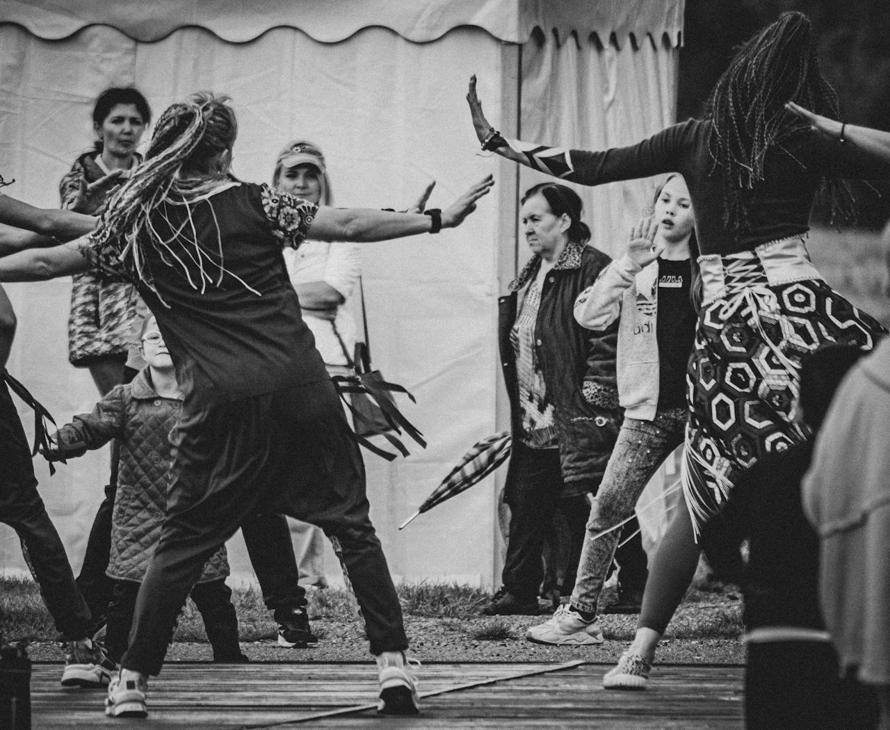 services-02 A lively scene of people dancing outdoors, showcasing cultural expression.