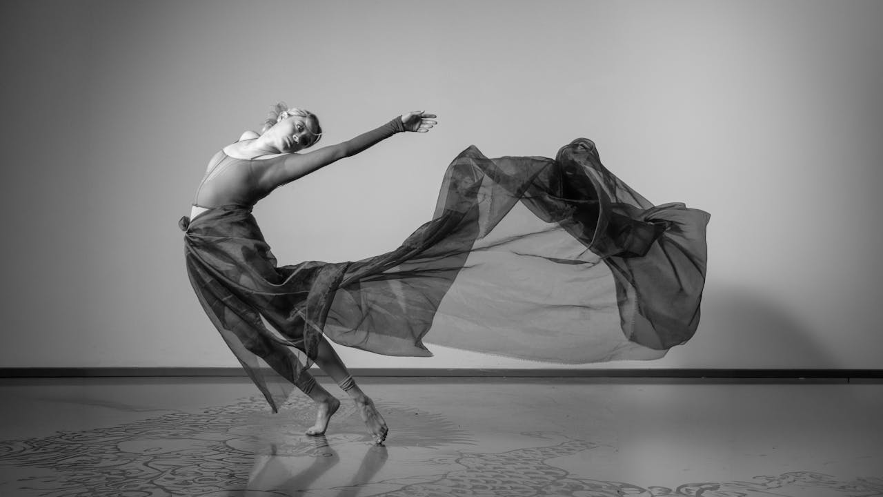 services-03 A captivating black and white shot of a contemporary dancer mid-motion, showcasing elegance and fluidity.