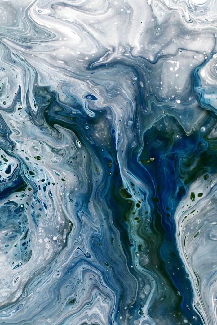Captivating fluid art with swirling blue and white patterns and textures.