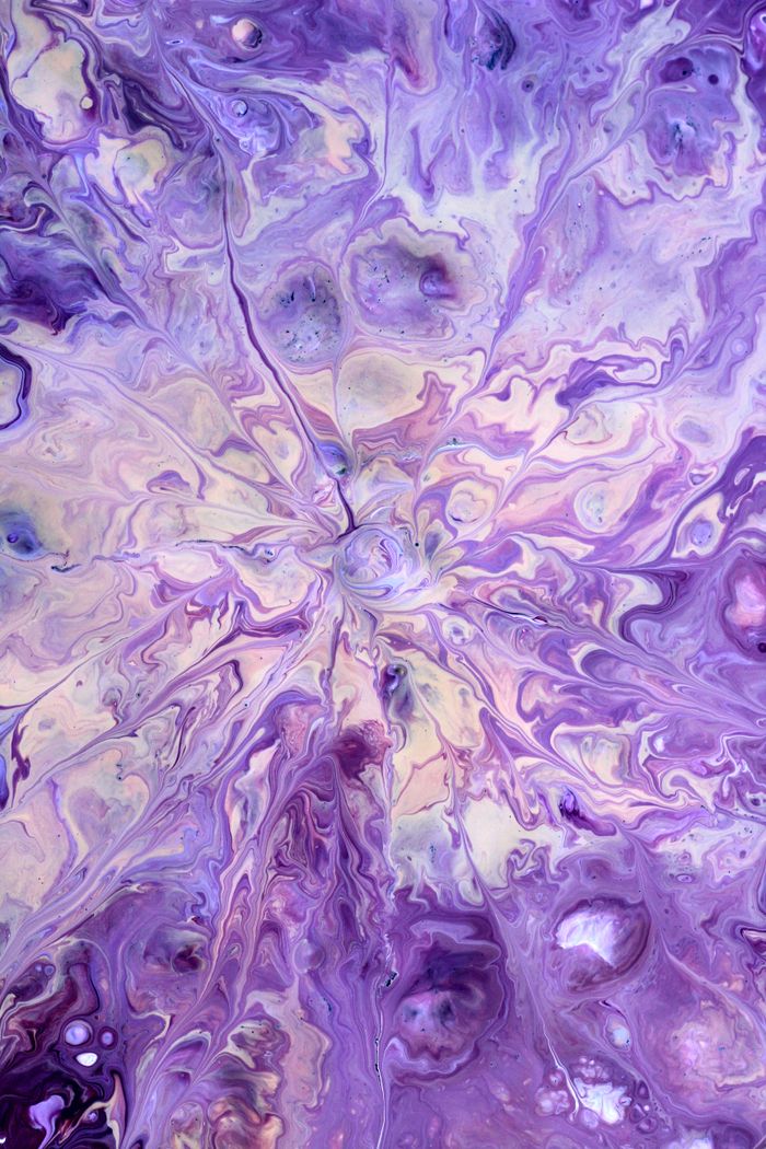 Dynamic purple fluid art depicting organic forms and swirling patterns.