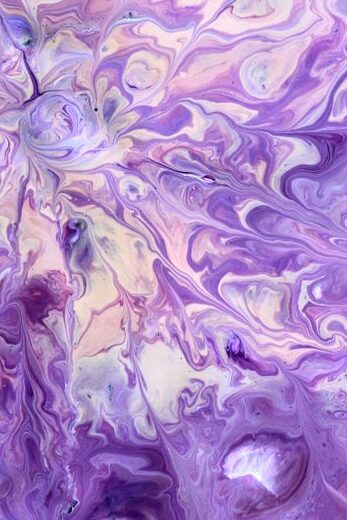 Dynamic purple fluid art depicting organic forms and swirling patterns.